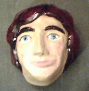 Caption: I made this clay sculpture of Luke’s smirking face a number of years ago. Why I didn’t post a good picture of it on this blog before… I don’t remember. It looks better in person than this photo made by my old-style cell phone.